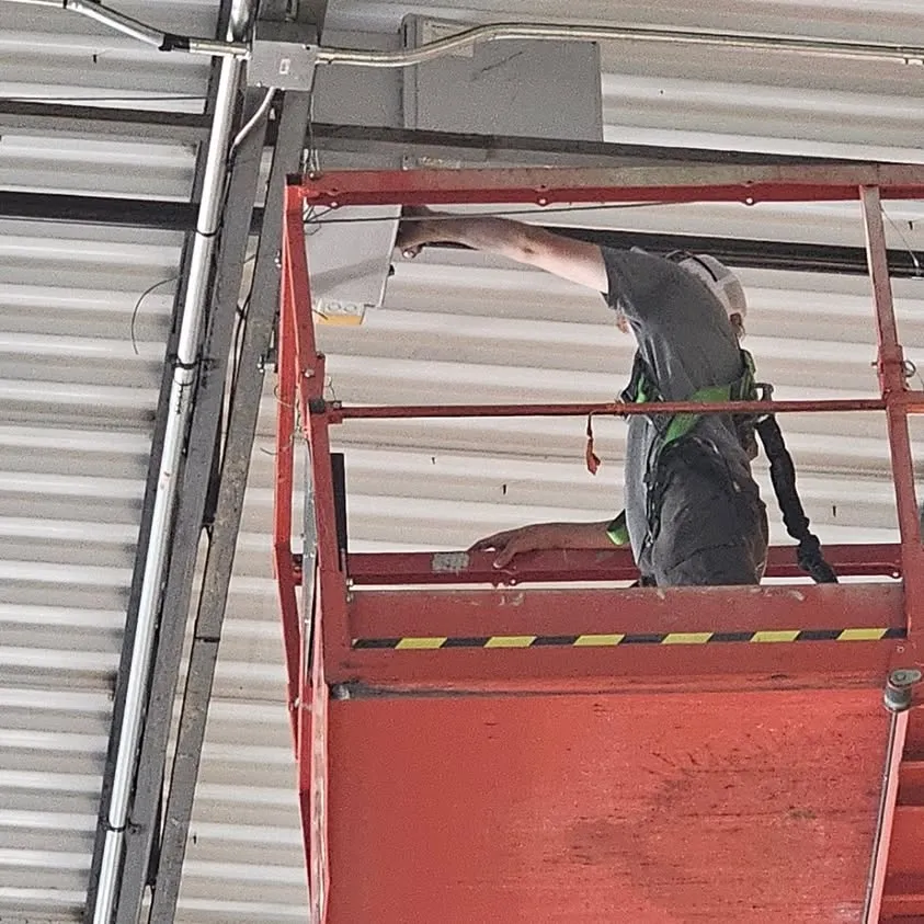 Up on the lift installing fan wiring in Arlington