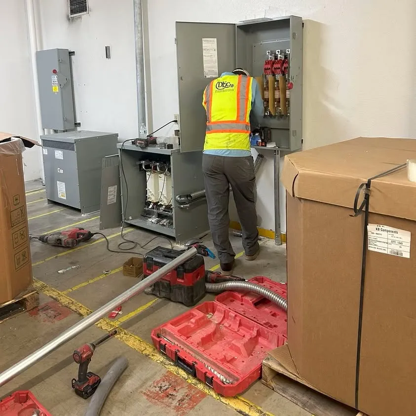 Wiring injection mold machines at a plant in Arlington