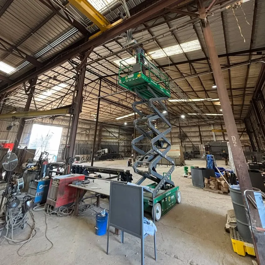 Pulling wire overhead from a lift for new machinery at a Hurst steel plant