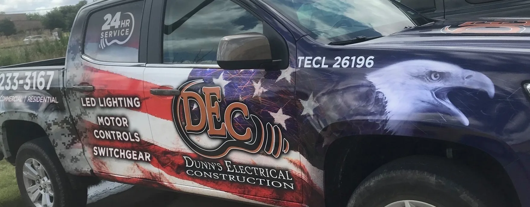 A Dunn’s Electrical Construction service truck wrapped in the American flag and an eagle, lettered “24 hr service”, “LED lighting, motor controls, switchgear” and “TECL 26196”